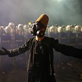 A demonstrator wearing dervish clothes and a gas mask stands in front of riot police during protests in Istanbul. Murad Sezer-Reuters.jpg